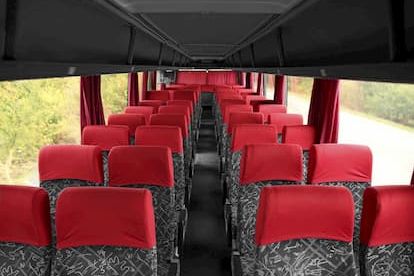 Interior of charter bus with red seats